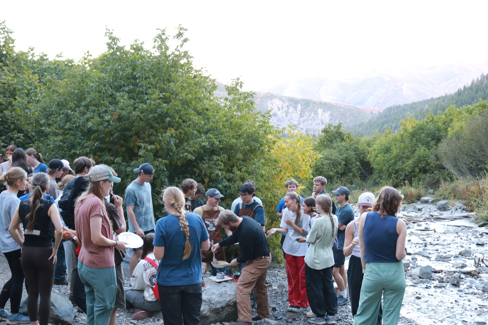 Friends gathering beside the stream at Stewart Falls